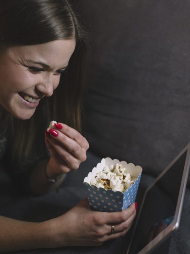 cheerful-woman-watching-film-tablet